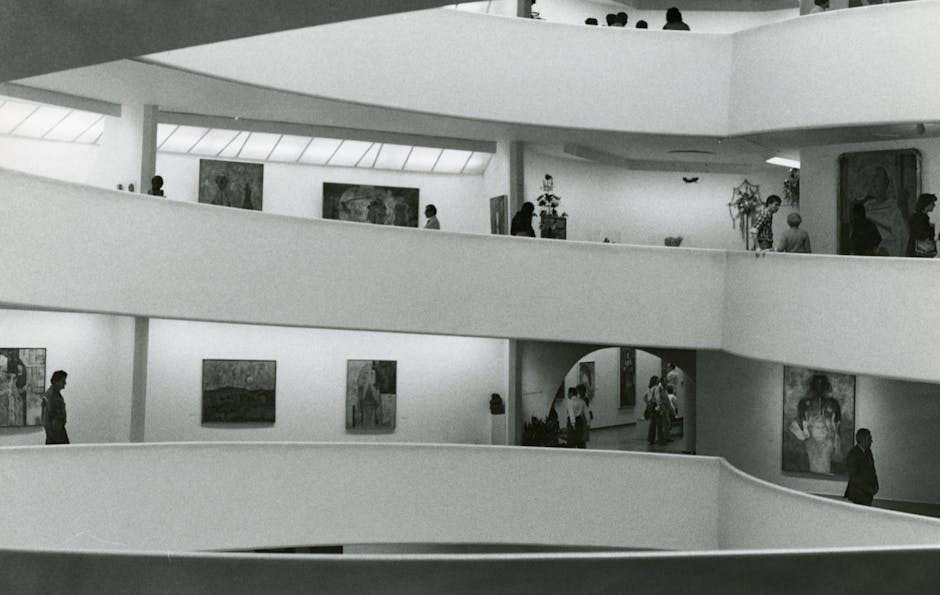 Black and white photo of a modern art museum interior with paintings and visitors.